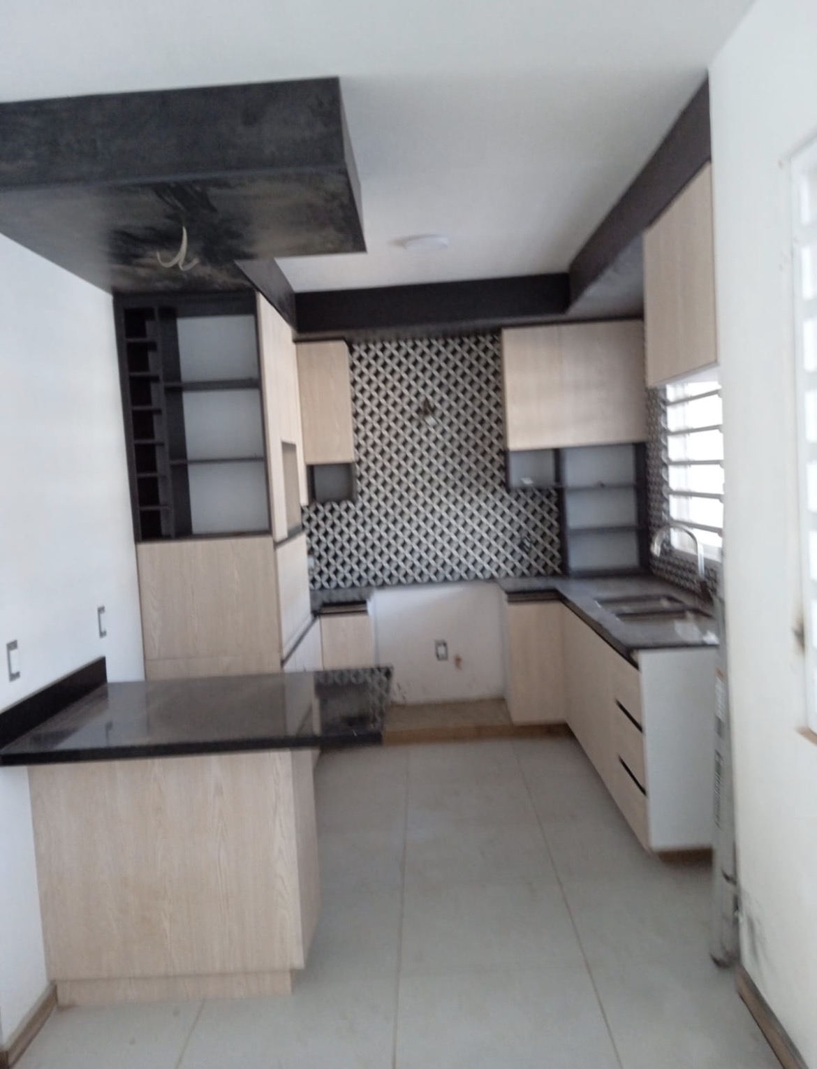 Light oak U-shaped kitchen with granite counters