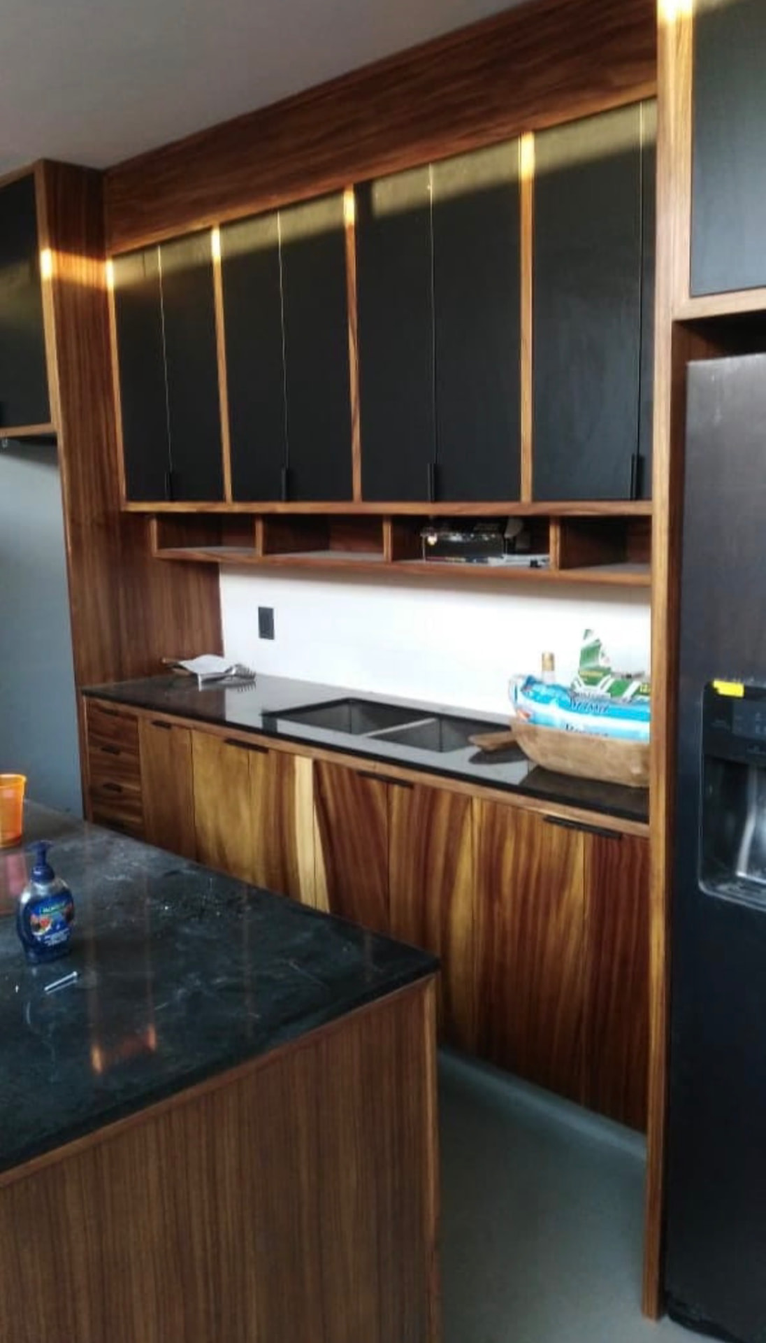 Tropical hardwood kitchen with matte black uppers