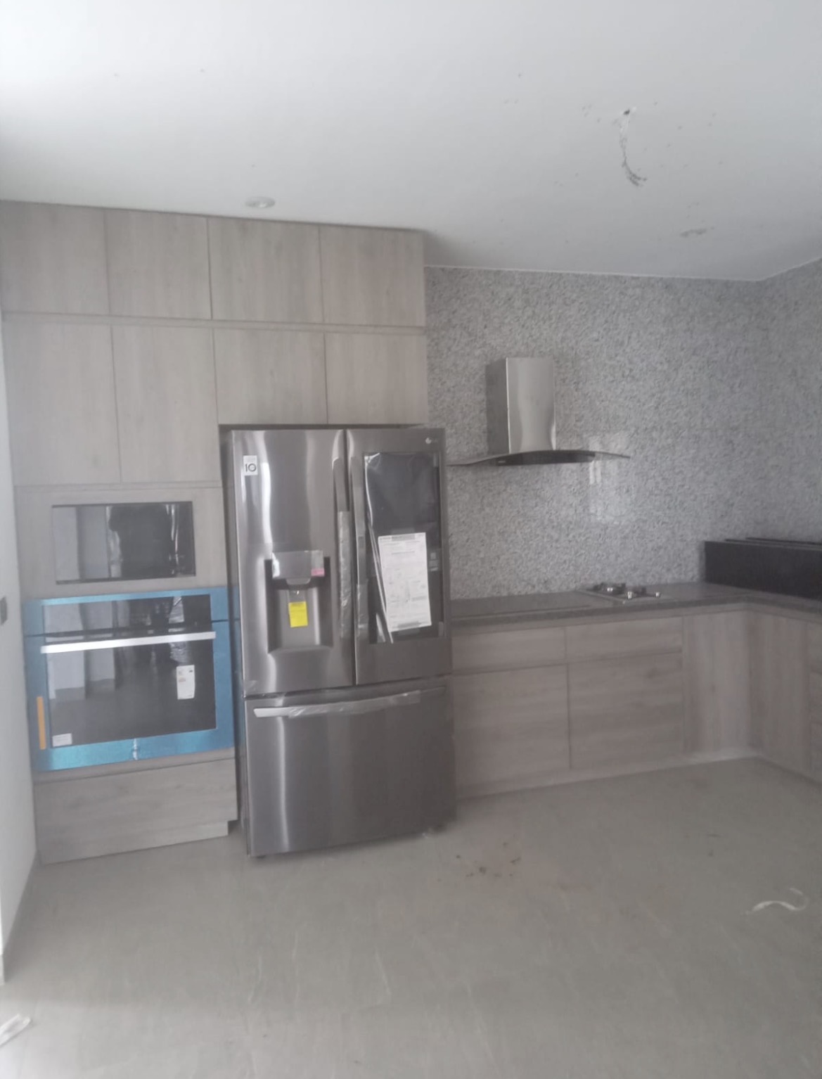 Light oak floor-to-ceiling kitchen with appliance tower